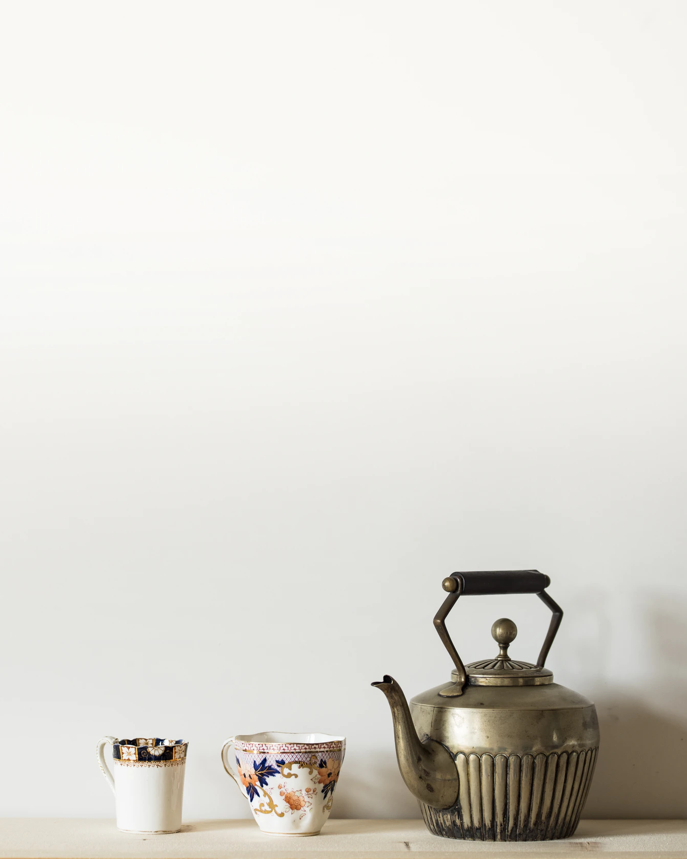 Beige background image with a tea set in the foreground.